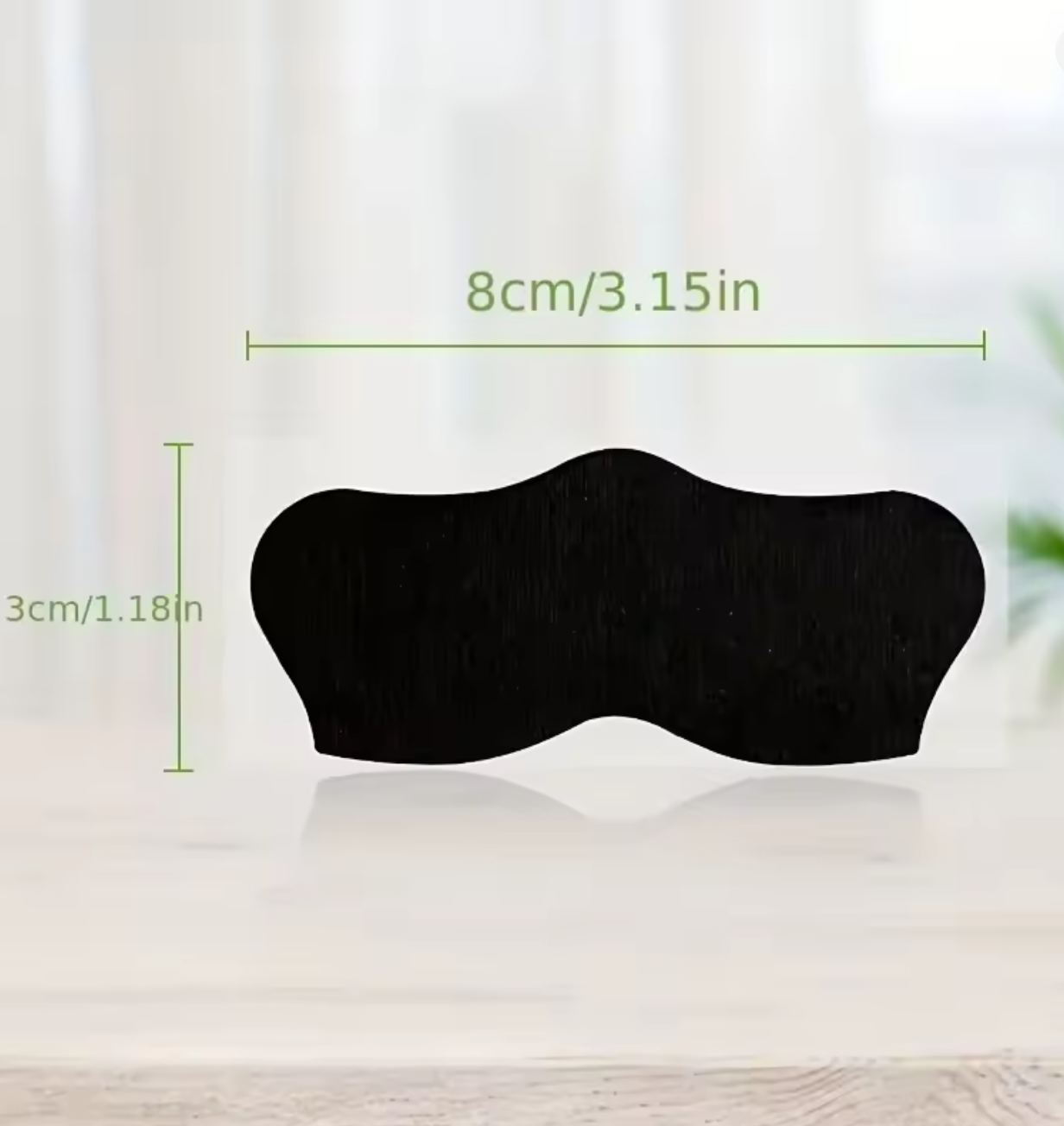 Black eye mask with measurements on a light background